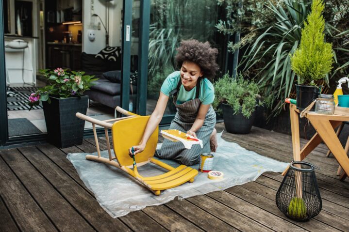 woman-painting-chair-yellow-getty-0421-2000