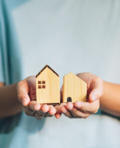Close up woman holding home model ,New house planing,Home loan, real estate concept