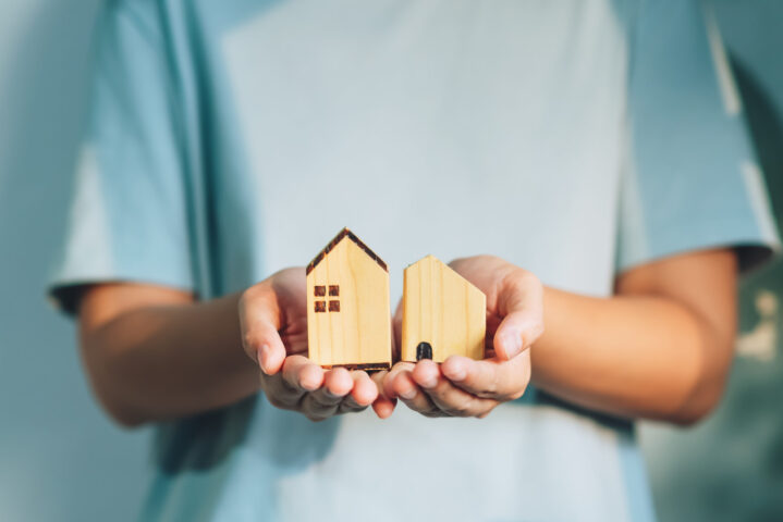 Close up woman holding home model ,New house planing,Home loan, real estate concept