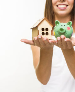 smiley-woman-holding-wooden-cottage-piggy-back