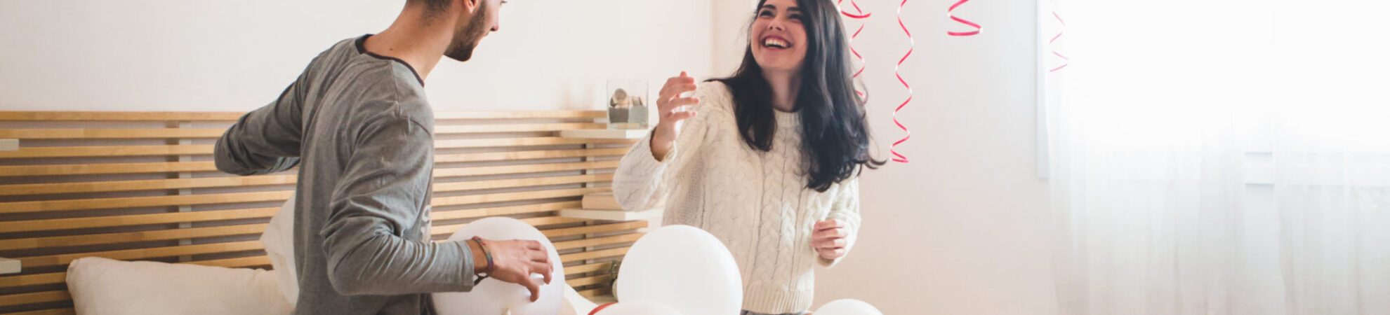 smiling-girl-looking-balloons-roof