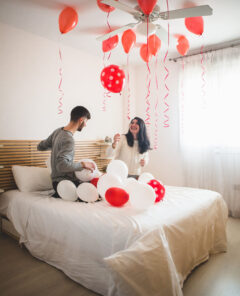 smiling-girl-looking-balloons-roof