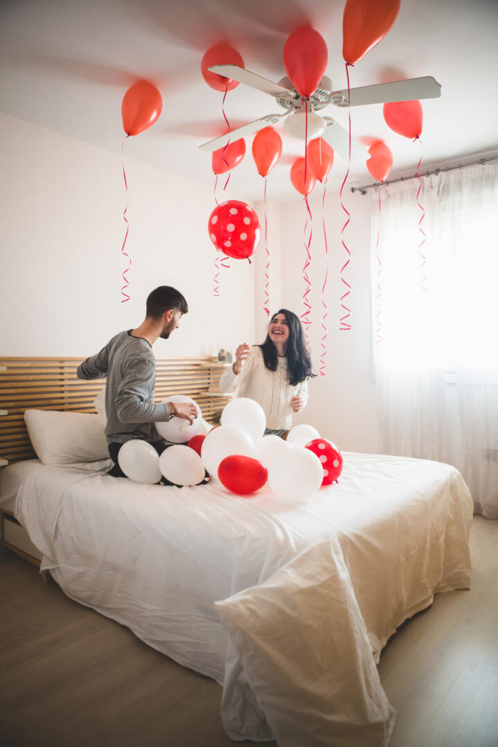 smiling-girl-looking-balloons-roof